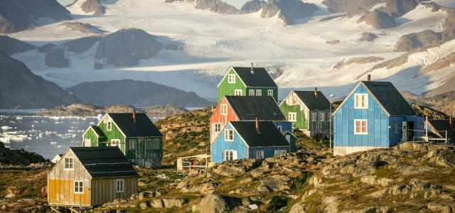 Colorful houses nestled in a rocky, mountainous landscape. by Nick Russill courtesy of Unsplash.